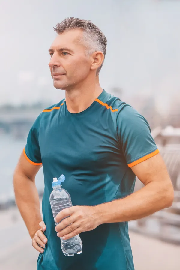 Cardiovascular-Health-Treatment A middle-aged man hydrates after a hard workout. Get cardiovascular health care from Better Life Carolinas of Charlotte in Charlotte Metro.