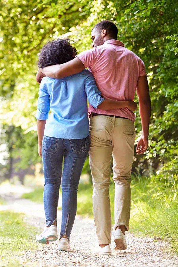Epithalon-Peptide-Treatment A Black couple walk arm and arm on a trail. Get Epithalon Peptide therapy from Better Life Carolinas of Charlotte in Charlotte Metro.