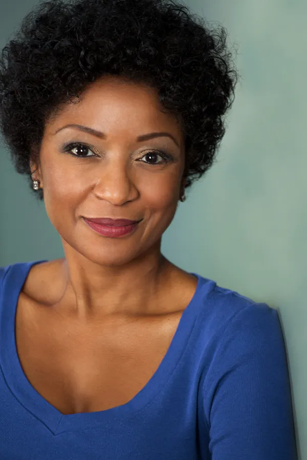Femiwave-Treatment A middle-aged black woman in a blue shirt smiling. Get FemiWave treatment from Better Life Carolinas of Charlotte in Charlotte Metro.