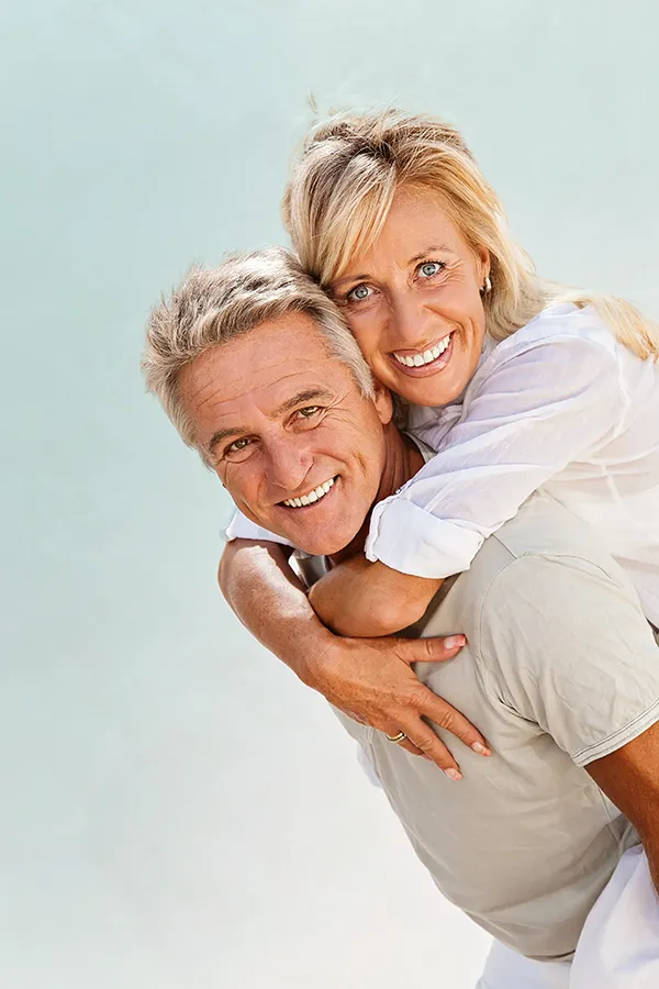 Food-Allergies-Treatment-1 A happy mature couple having fun - the husband is carrying his wife on his back. Get treatment for food allergies from Better Life Carolinas of Charlotte in Charlotte Metro.