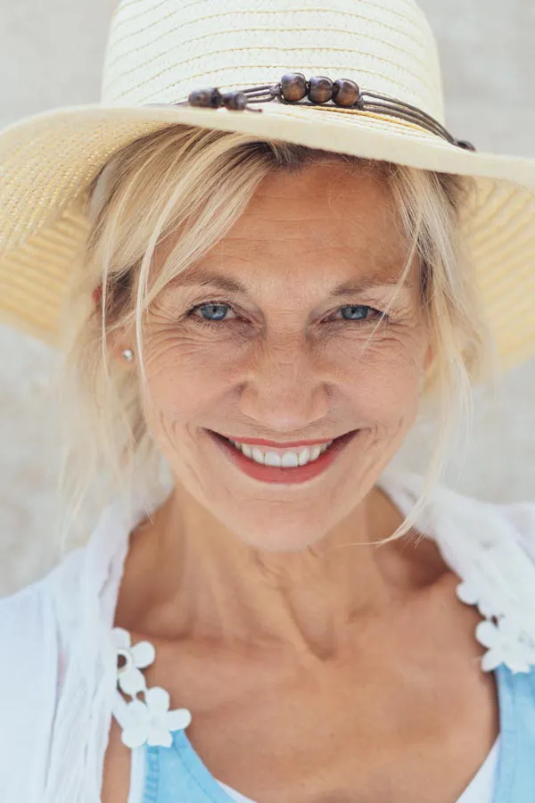 Menopause-Treatment A beautiful, smiling older woman with blonde hair and a sunhat, happy with menopause treatment from Better Life Carolinas of Charlotte in Charlotte Metro.