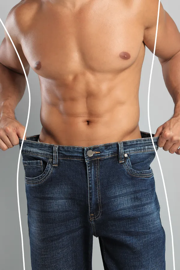 Semaglutide-Weight-Loss-Treatment A strong shirtless man in jeans holds the waistlines of his too-big jeans to show the success of semaglutide weight loss from Better Life Carolinas of Charlotte in Charlotte Metro.