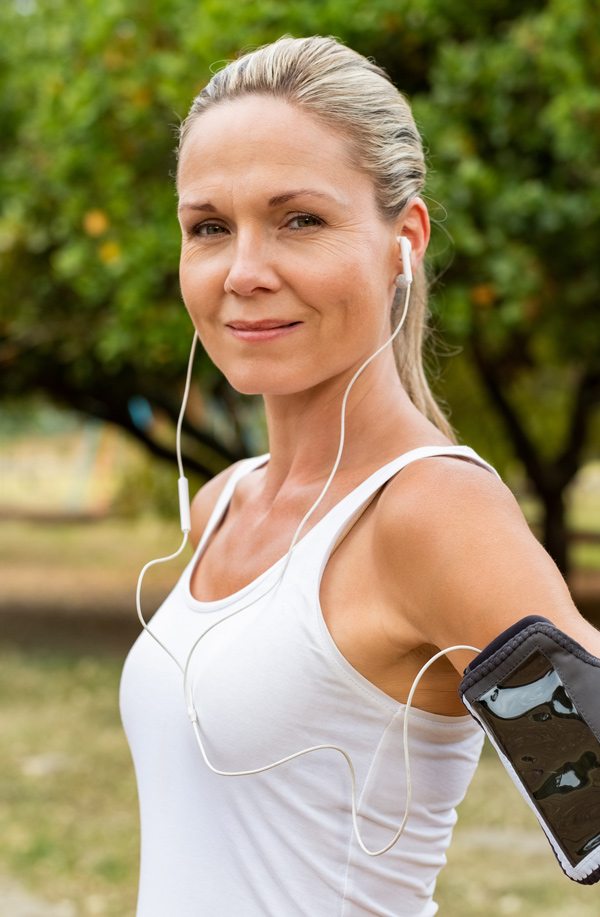 fibromyalgia-doctor Middle-aged, active woman taking a break to smile at the camera during a run, representing successful Bioidentical Hormones for Fibromyalgia Relief offered by Better Life Carolinas of Charlotte in Charlotte Metro.